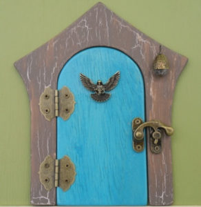 blue handcrafted faerie door with brown frame