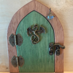 green handcrafted faerie door with dragon charm and brown frame