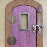 purple faerie handcrafted faerie door with window and brown frame