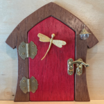 red handcrafted faerie door with dragonfly charm and brown frame