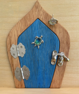 ocean blue handcrafted faerie door with turtle charm and brown frame