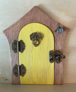 yellow handcrafted faerie door with brown frame