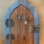 brown handcrafted faerie door with blue frame