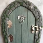 thicket blue handcrafted faerie door with dragon charm and stone frame