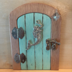 aqua handcrafted faerie door with mermaid charm and brown frame