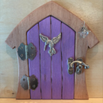 purple handcrafted faerie door with brown frame