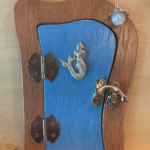 blue handcrafted faerie door with mermaid charm and brown frame